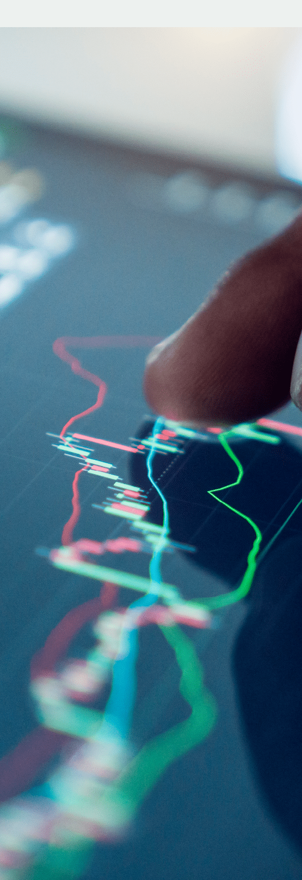 Market Analyze with Digital Monitor focus on tip of finger.